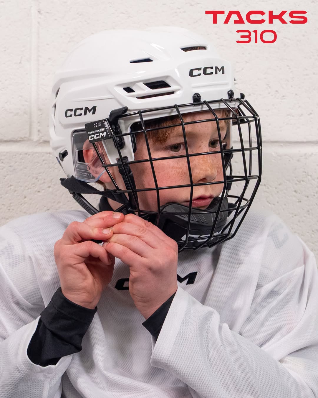 Hockey kid doing up helmet